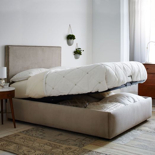 a neutral upholstered bed that can be raised to store some things inside it is an ultimate idea to rock