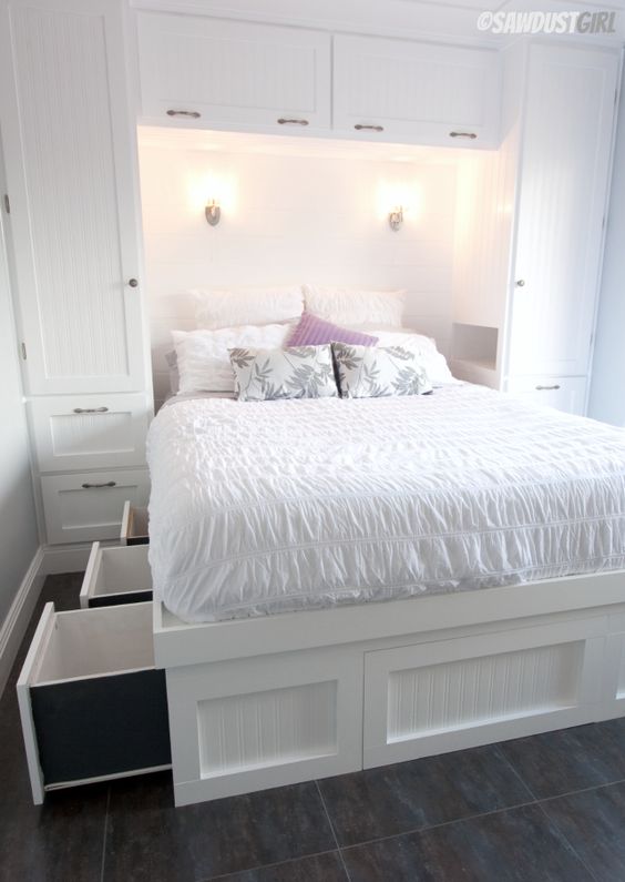 A white built in bed with storage drawers in the sides of the bed is a cool idea to go for