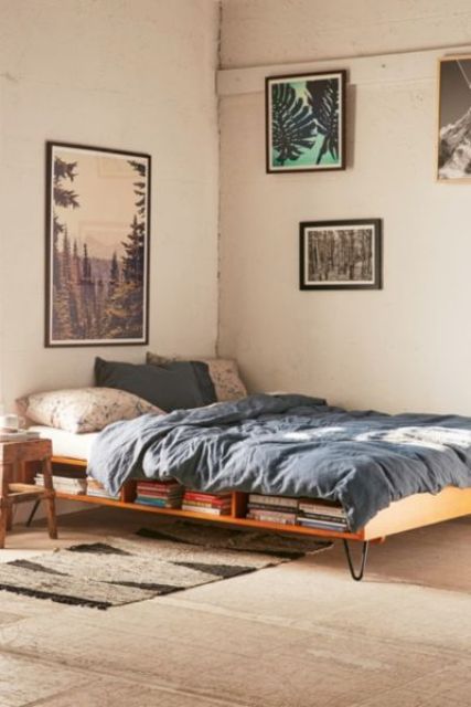 A mid century modern wooden bed with open storage compartments and pin legs is stylish and chic