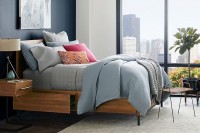 a sleek mid-century modern wooden bed with invisible drawers in the sides is a lovely idea and your storage space is hidden