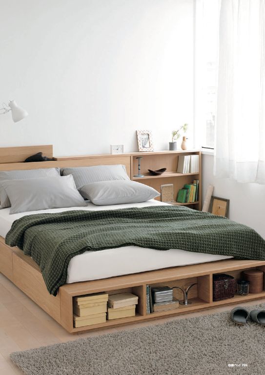 A minimalist light stained bed with side drawers and an open storage compartment at the foot of the bed plus storage nightstands is a cool solution for a small bedroom