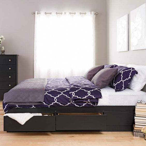a minimalist dark stained bed with side drawers to hide various stuff you don't need at the moment
