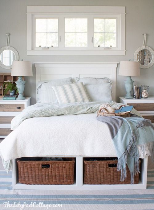 a comfy white bed with open storage compartments finished with basket drawers that add coziness and a rustic feel to the piece
