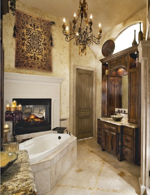 An eclectic bathroom with dark stained wooden storage, a built in fireplace, a bathtub clad with tiles, a vintage chandelier and candles