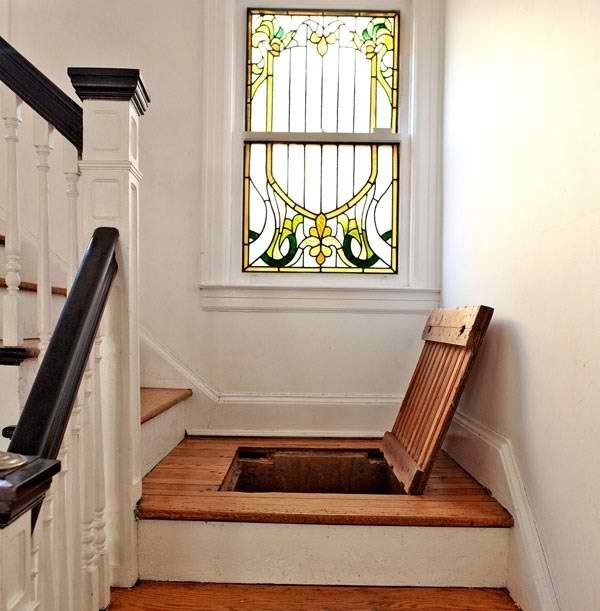 A staircase with storage and a stained glass window is a lovely idea for a modern and not only modern space, it makes it eye catchy