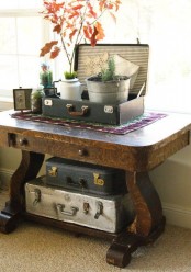 a console table with two suitcases inside it for storing some things that you don’t want to show off