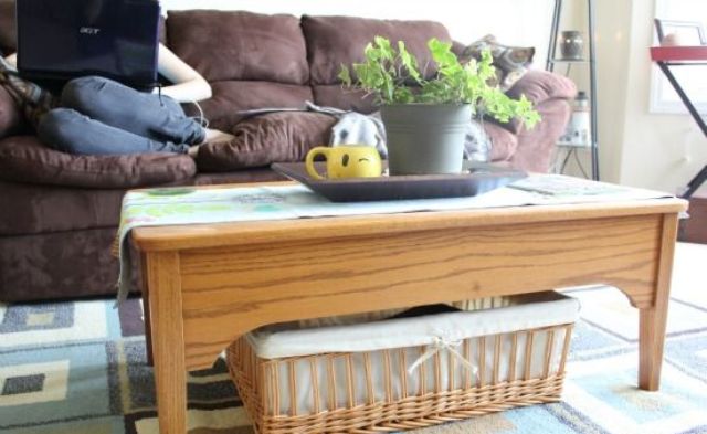 A lwo wooden coffee table with a basket for storage is a cool and cozy rustic idea