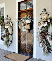 chic natural front door styling with mesh and burlap ribbons, evergreens, pinecones, berries, and whitewashed evergreens on the door