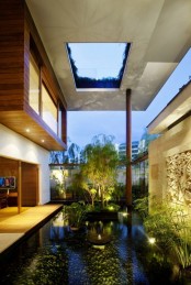 a whole water garden indoors – with a pond, lots of plants, artworks and some lights to accent it is a very zen space