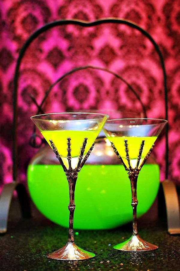 Neon green Halloween drinks in glasses holded by skeleton hands   yes, please