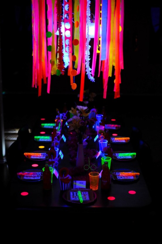 a modern and bright Halloween party space with a neon chandelier, glasses, menus and lights is awesome and very inspiring