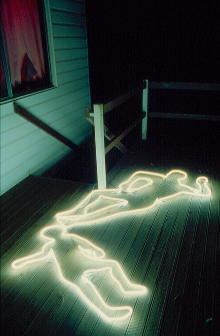 neon lights on the porch showing off some human corpses is a cool and modern idea for outdoor Halloween decor