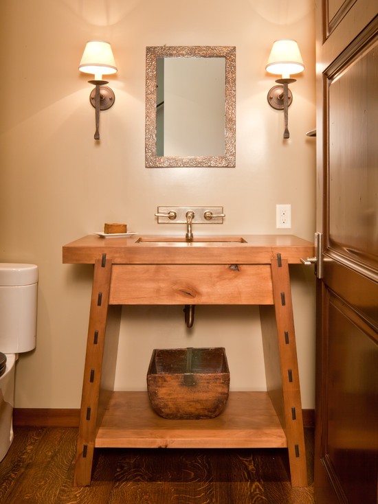A simple stained wooden vanity with a built in sink is a stylish idea for a rustic bathroom