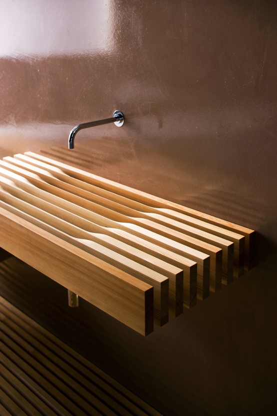 A very eye catchy light stained wooden slab wall mounted sink is a very unusual and very creative idea