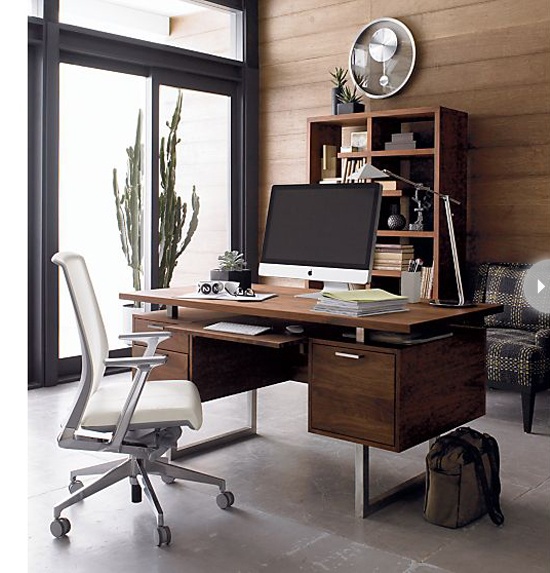 a stylish contemporary home office done with a wood statement wall, a wooden desk, a plaid chair and a potted cactus