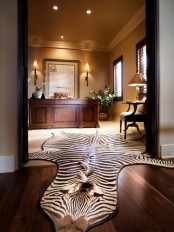 a luxurious home office with neutral walls, a refined desk, a faux animal skin and elegant lamps