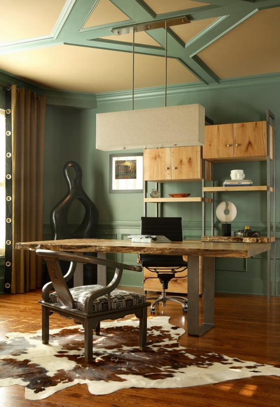 a catchy home office done with aqua touches, a metal and wood desk, an animal skin rug, a unique shelving unit with open shelves and cabinets