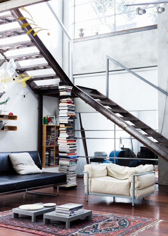 a gorgeous aged metal staircase makes a statement, metal furniture echoes with it and adds to the space
