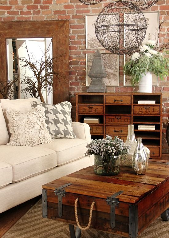 brick walls, wood and metal coffee table, a vintage wooden storage unit