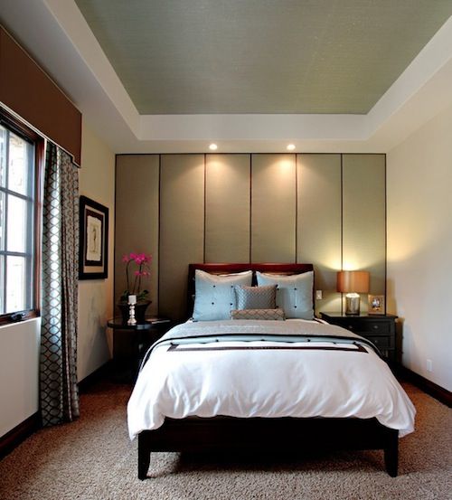 a soundproofing headboard wall done with large neutral-color panels that also form a statement wall
