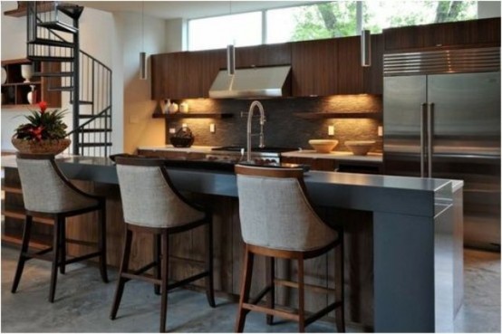 a stained wooden kitchen island with metal appliances, a raised countertop for eating and comfy stools