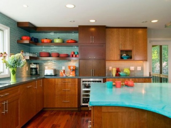 a turquoise and rich-stained mid-century modern kitchen with an arched kitchen island with a turquoise countertop