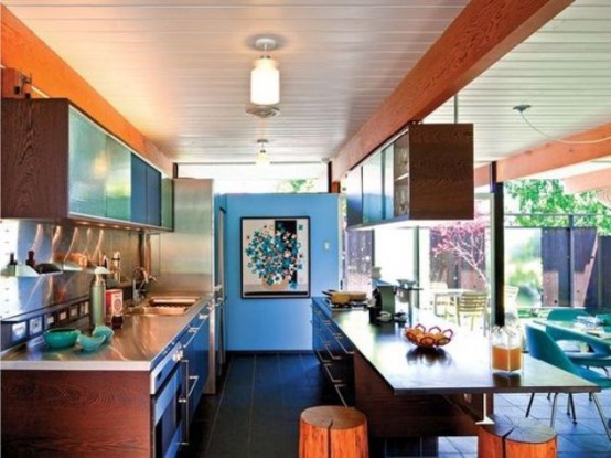 a mid-century modern kitchen with rich-stained cabinets, a large kitchen island with an eating space and uppers over it