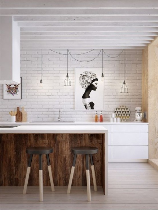 a mid-century modern meets industrial kitchen with a white brick wall, a white kitchen island with stools, black wire pendant lamps