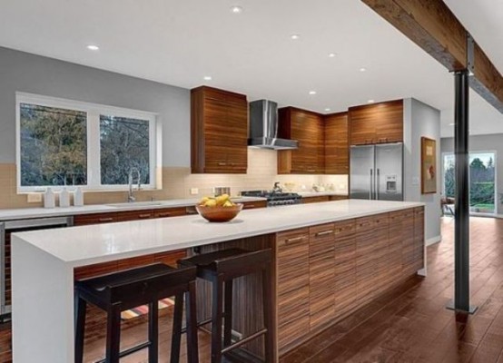 a rich-stained and white mid-century modern kitchen with a large kitchen island with an eating space