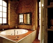 rough brick walls make this modern bathroom bolder and cooler, and a framed window gives light
