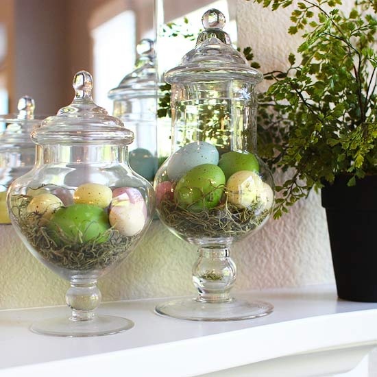 large jars with hay and colorful Easter eggs on the mantel is a cute and easy to realize idea