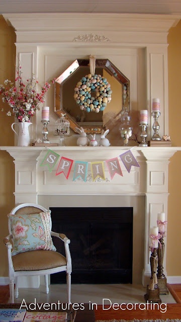 a colorful bunting, a pastel faux egg wreath, some candles and fake bunnies