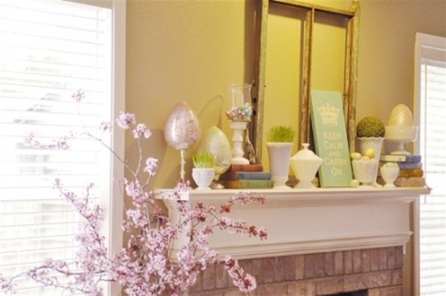 A pastel Easter mantel with faux eggs, egg arrangements in a bowl and grass in pots