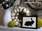 vintage styling with a fake Easter egg wreath, moss and berry balls and bloomign branches