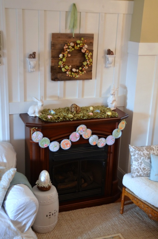a cute Easter mantel with a pastel egg wreath, a moss decoration with pastel eggs and a vintage paper bunting