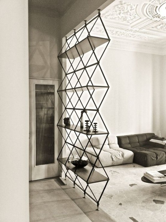 a geometric shelving unit separating the spaces, the living room and entryway, is a stylish idea for a modern space, it's airy and cool