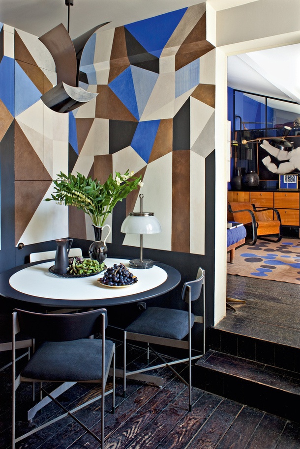 A chic bright geometric wall in blue, brown and neutrals that takes over the whole space and accents it a lot