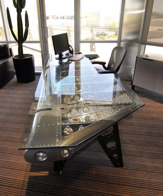 a striking metal and glass desk with large legs and beautiful inside under the glass desktop is a fantastic statement for your home office