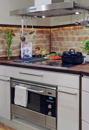 a red brick backsplash is a catchy idea for any kitchen, besides it’s very budget-friendly and adds texture