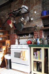 a whitewashed red brick wall is a cool idea for an eclectic kitchen like this one