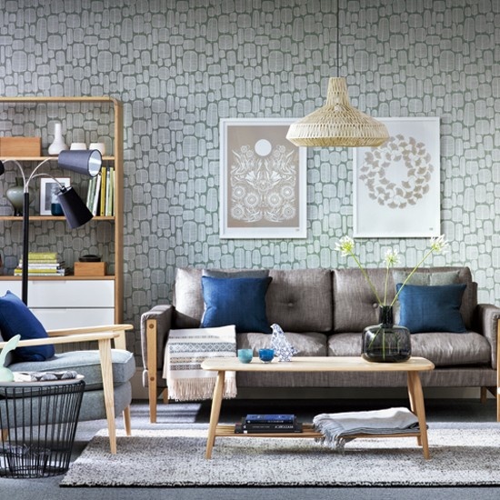 An eclectic living room with mid century modern furniture, wicker lampshades and neutral artworks