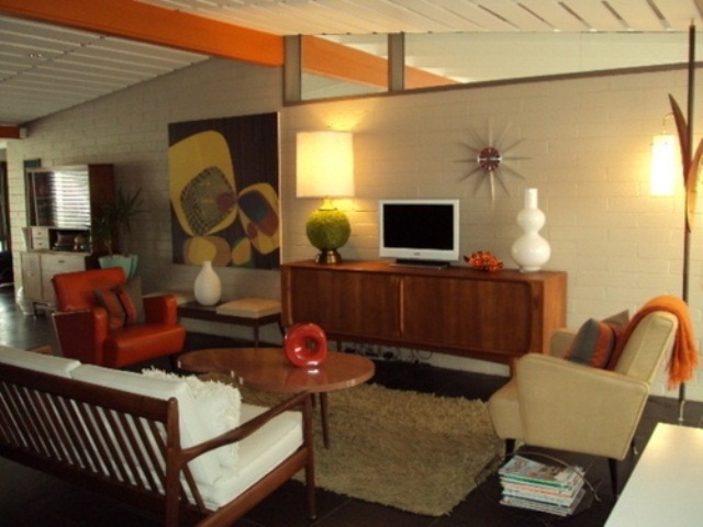 A neutral living room with touches of orange and amber plus elegant warm colored stain on the furniture