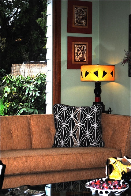 A cozy mid century modern living room with touches of African and Asian cultures and greenery