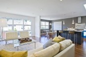 an airy and neutral living room with neutral furniture, bright touches and lamps all over