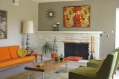 a space done in orange and green, with abstract prints, potted greenery and lamps