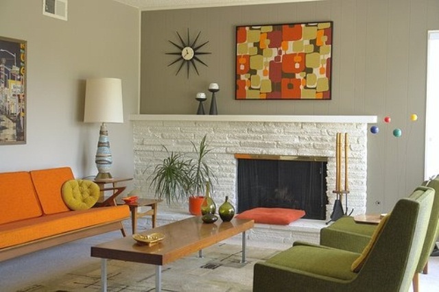 A space done in orange and green, with abstract prints, potted greenery and lamps