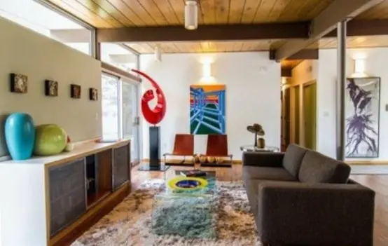 a bright mid-century modern space with colorful touches - green, blue, red and yellow and a chocolate brown sofa