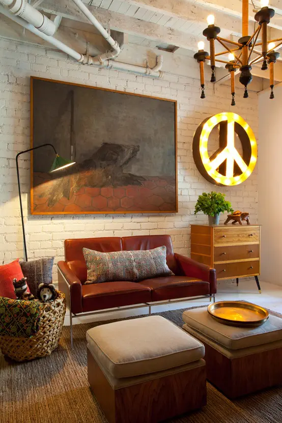 An eclectic living room with industrial touches, mid century modern furniture and creative artworks