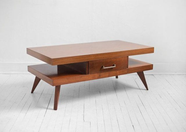A rich stained mid century modern coffee table with two tabletops, a small drawer for hiding stuff