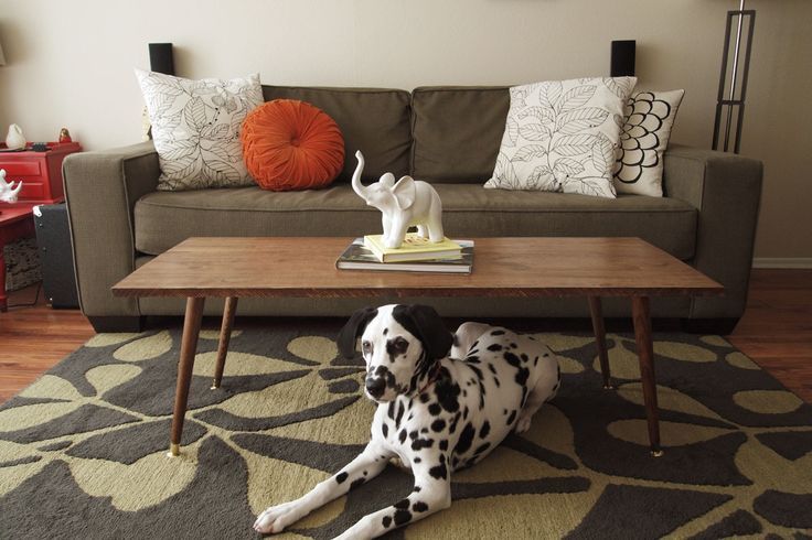 A classic rich stained coffee table with tapered legs is a cool and timeless addition to a mid century modern or Scandinavian space